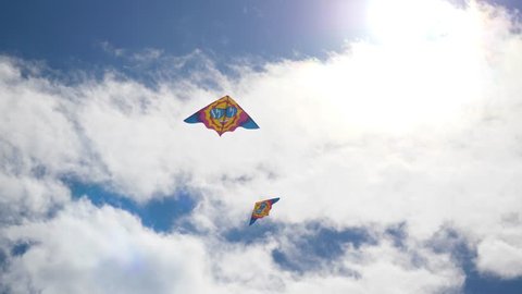 Kites in the sky. Colorful kites flying in blue sky. Under the blue sky flying kites