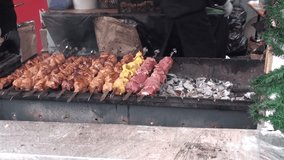 Pieces of juicy meat on skewers roasted on the grill. Full HD 1920x1080 Video Clip