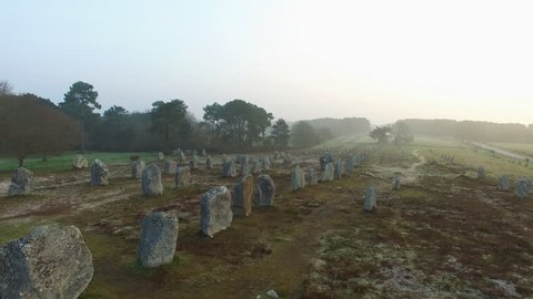 Flying over the famous "Alignements de Carnac" located in Carnac, Morbihan, Brittany, France. Sunrise on the Megaliths of Kermario, one of the largest Megalithic complex in the world.