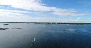 Sailboat regatta, Cinema 4k aerial view of a lot of sailboats in the baltic sea and heading towards hanko city, out on the finnish archipelago, turquoise sea