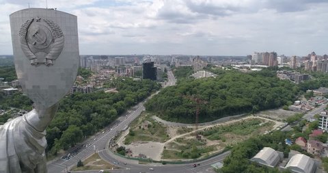Ukraine. Kiev. June 11, 2017. Motherland. Aerial photography. 4K video. Summer. Overcast. Panorama. Building. Sculpture. Museum of the History of Ukraine in World War II. Victory Day. Road. Cars.