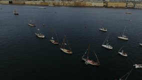 Aerial video of bay with floating sailing yacht fleet in marina during yachting regatta race