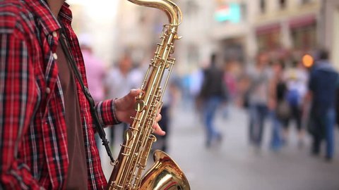 man playing saxophone on the street Stock Video