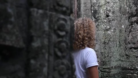 Curious Traveler Female Sightseeing In Angkor Wat In Cambodia. Siem Reap, Cambodia. HD, 1920x1080. Slow Motion. 