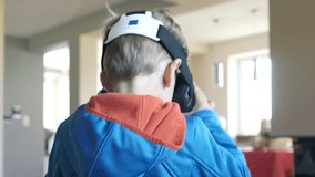 Boy with vr goggle watching video at home
