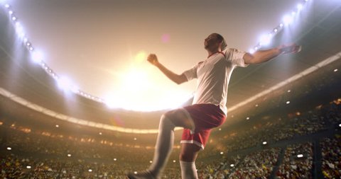 4k footage of a soccer player in dramatic play during a soccer game on a professional outdoor soccer stadium. Player wears unbranded uniform. Stadium and crowd are made in 3D.
