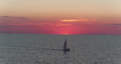 top view of boat in sea at pink sunset