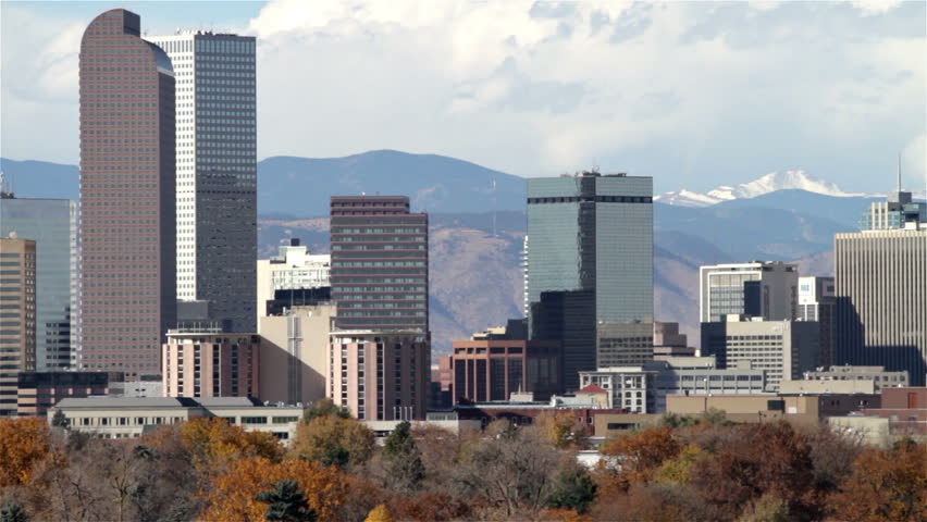 Slow zoom-out of the Denver, Colorado skyline, with City Park in the foreground.