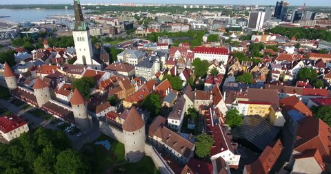 The tallest tower of the Old Town is a Saint Olaf church. Tiled roofs and strong walls of fortress. Estonia, Europe. Aerial view