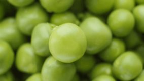 Fresh green peas rotate. Top view. Close up