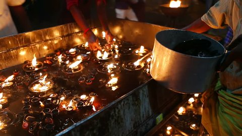 Candle flame close-up in the Indian Temple on a Religious Festival Diwali. Oil Lamp in Beautiful candlestick. Spiritual, Mystical and Religious Traditions of India. Beautiful bright festive lights స్టాక్ వీడియో