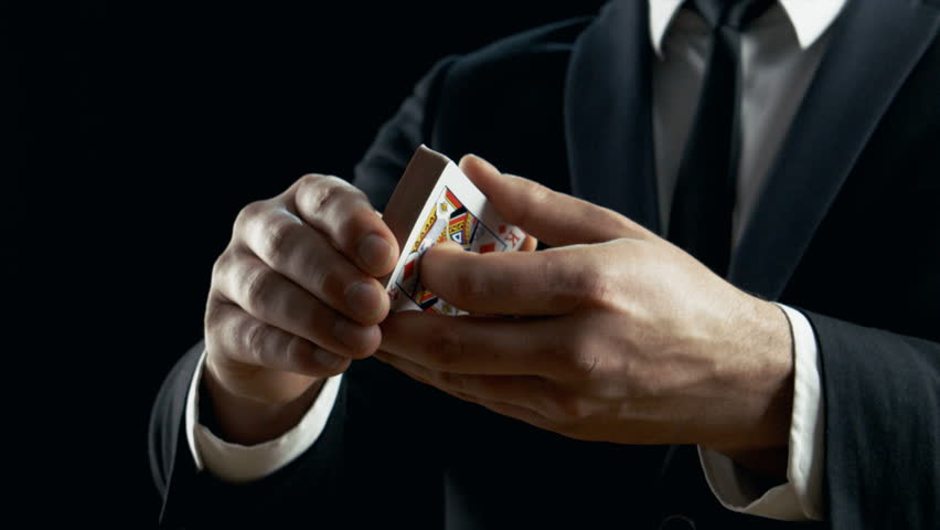 Close-up of a Magician's Hands Performing Card Trick. Throwing and Catching Cards in the Air. Background is Black. Slow Motion. Shot on RED EPIC-W 8K Helium Cinema Camera. Royalty-Free Stock Footage #28898332