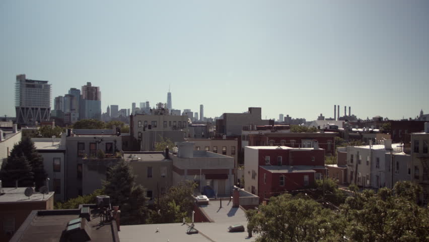 Rooftops of Brooklyn. Manhattan skyline. New York. Greenpoint, polish neighbourhood. Chimneys. Buildings under construction on Williamsburg waterfront. WTC One and Trump Building seen in the distance.