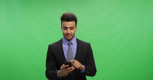 Cheerful Businessman Talking Online Use Cell Smart Phone Making Video Call Over Chroma Key Green Screen Happy Smiling Young Latin Business Man Portrait
