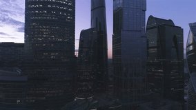 A night drone Aerial shot of skyscrapers of  business centre Moscow-city, 4K Ultra HD real time video. Urban scene of consulting company office. Camera moving forward between buildings. Moscow skyline