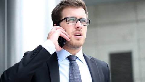 Handsome businessman talking at phone