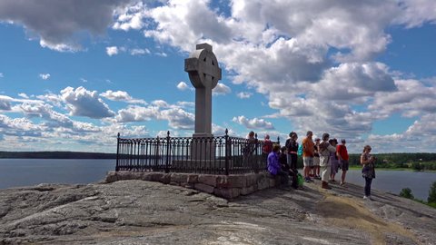 STOCKHOLM - JULY 18, 2017: Tourists by the monument of the missionary Ansgar on the Swedish island Bjorko, aka the viking island "Birka" frequented by many visitors to Sweden.