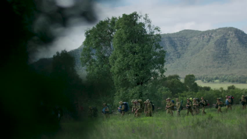 Army walking through field
