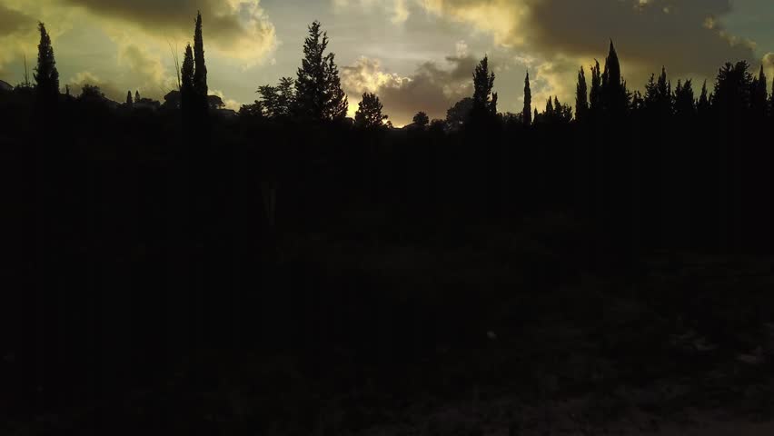 sunset over a mountain city - 4k aerial shot