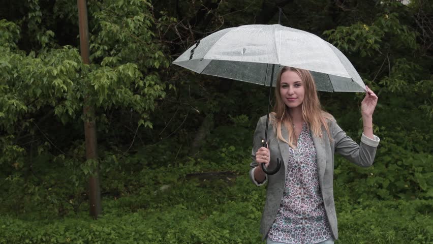 Girl with an umbrella in heavy rain