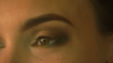 young girl makes eye makeup