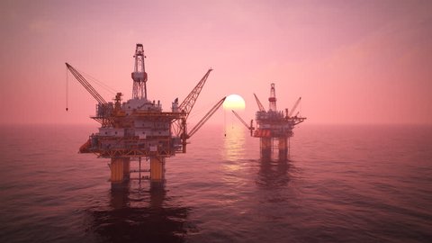 02834 Two offshore platforms or oil rigs at sunset pink sky