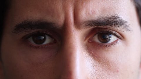 Man closes and opens eyes. Man gives an expressive smile with eyes. Closeup of eyes and facial expression of man in his 30s 