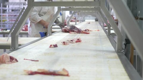 Workers prepare raw beef meat for delivery to stores
