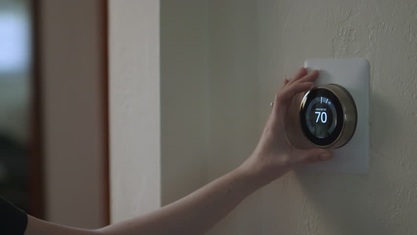 Woman Adjusting Smart Thermostat Gadget At Home | Shutterstock HD Video #28941733