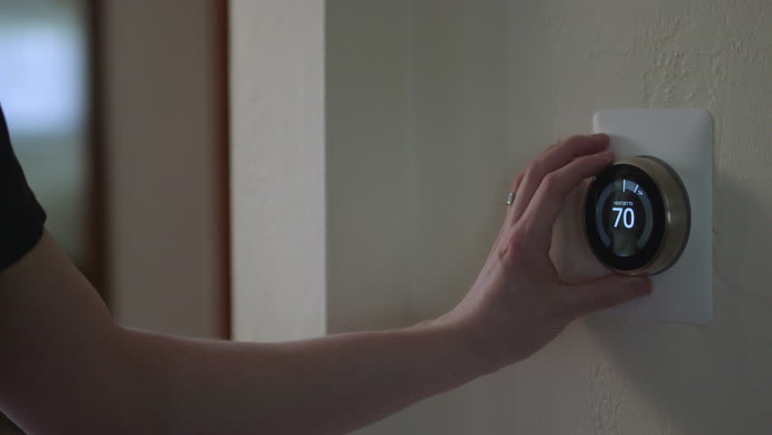 Man Adjusting Smart Thermostat Gadget At Home | Shutterstock HD Video #28941766