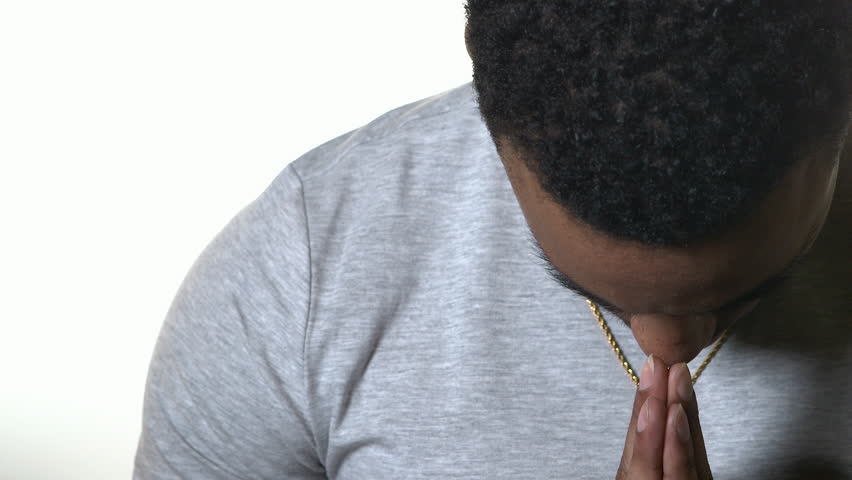 Young Male Praying in front of Seamless White Background | Shutterstock HD Video #28941778