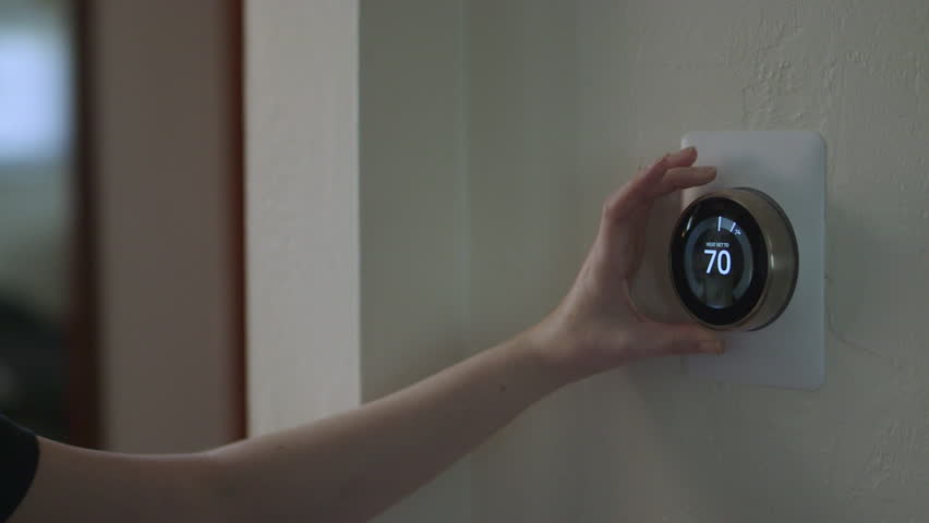 Woman Adjusting Smart Thermostat Gadget At Home | Shutterstock HD Video #28941781