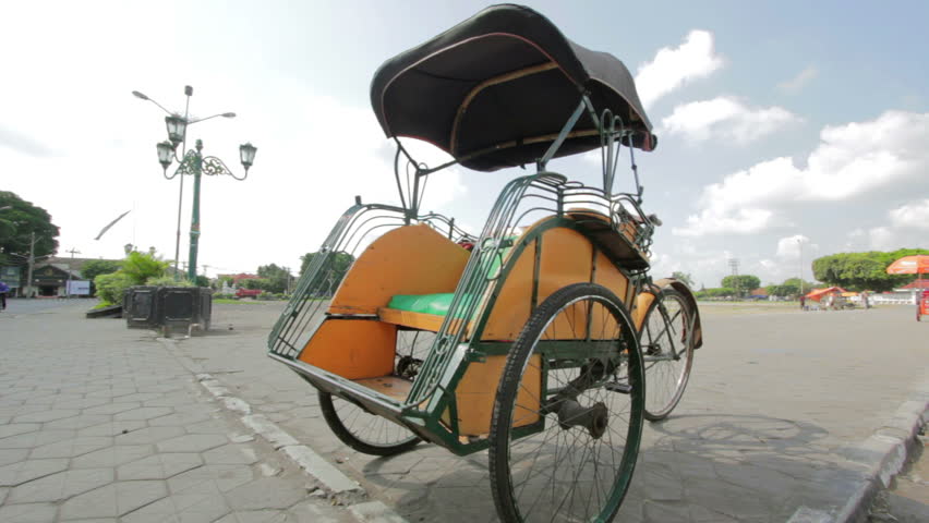 an orange rickshaw in Indonesia