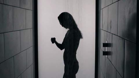 Silhouette of a sexy woman in a shower booth