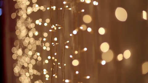 Christmas garland with Golden lights, close-up. Blurred Christmas lights. Bokeh.