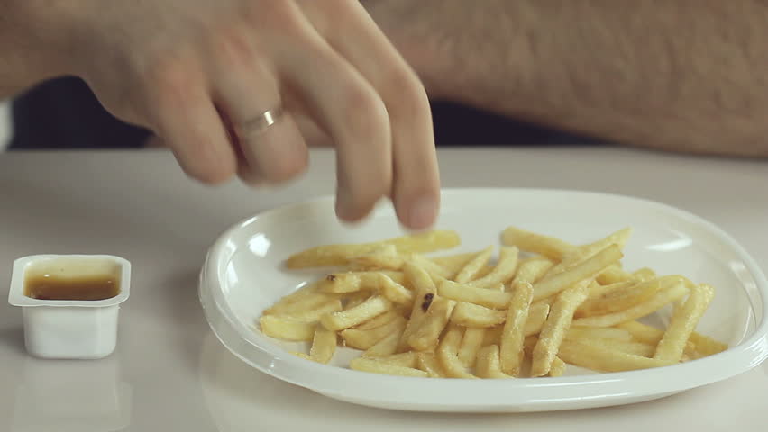 Man eats french fries