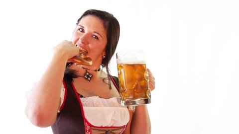 young pretty woman in dirndl with beer and pretzels