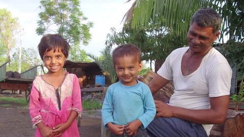 Fifty year old Indian man with grand son and daughter in the morning in rural village Salunkwadi, Ambajogai, Beed, Maharashtra, India, Southeast Asia