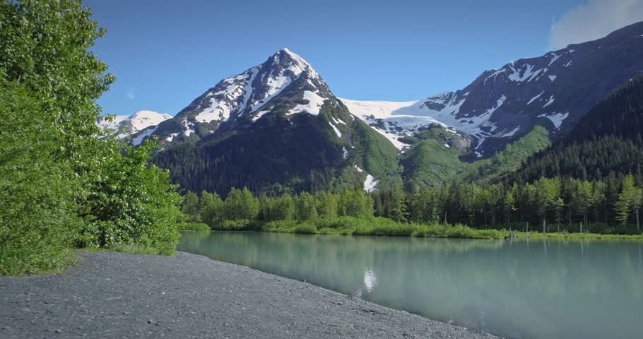 Aerial: flying over lake, mountain & trees near, Chugach Forest, Anchorage, Alaska
