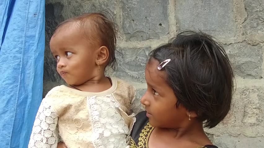 Girl carry small child in rural village Salunkwadi, Ambajogai, Beed, Maharashtra, India, Southeast Asia