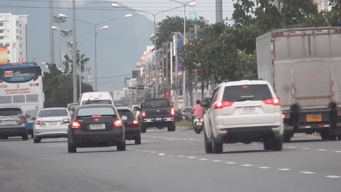 Rayong, Thailand - 20th July, 2017: Moving traffic on the main Sukhumvit Road in central Rayong City, early evening, Rayong.