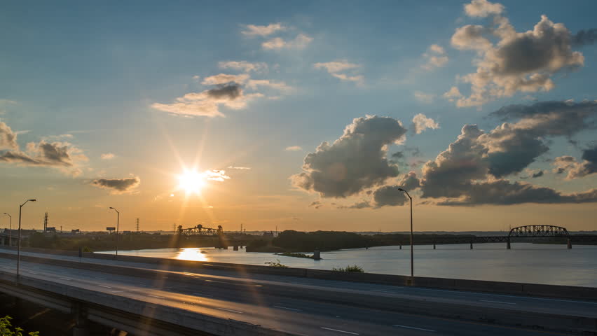 Louisville sunset time lapse over river 4k 1080p - time lapse of sun setting over river in downtown louisville kentucky