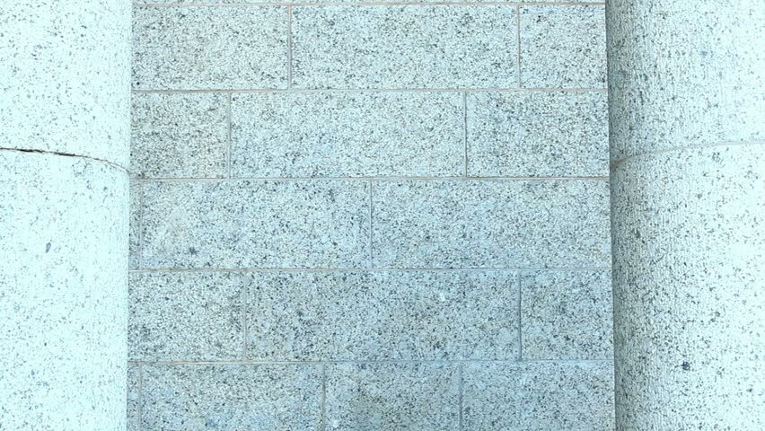 Two graduates giving high-five and embracing each other