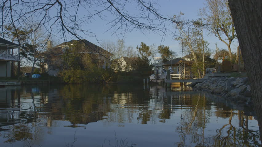 Sunset over Neighborhood with Natural Waterway and Boat Docks
