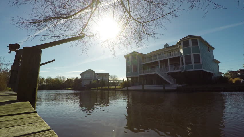 Timelapse of Sunset over Neighborhood with Natural Waterway and Boat Docks