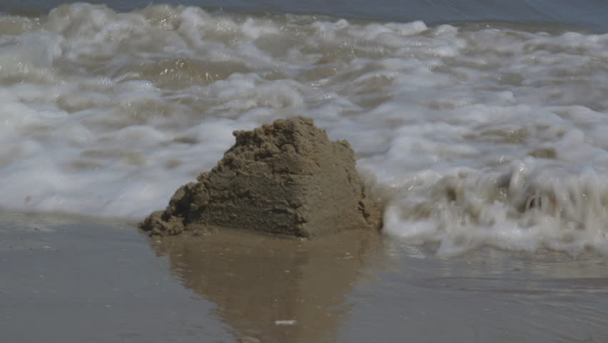 Ocean Waves Destroying Sandcastle on the Beach Royalty-Free Stock Footage #28991725