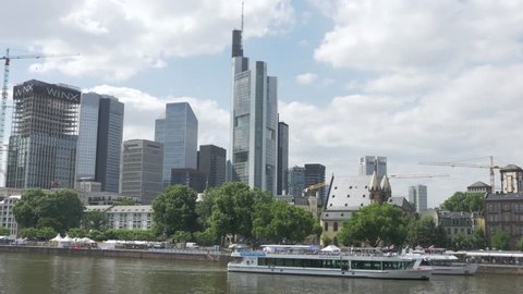 FRANKFURT, GERMANY, JULY 2017 - Boat in the Main river in Frankfurt cityscape skyline