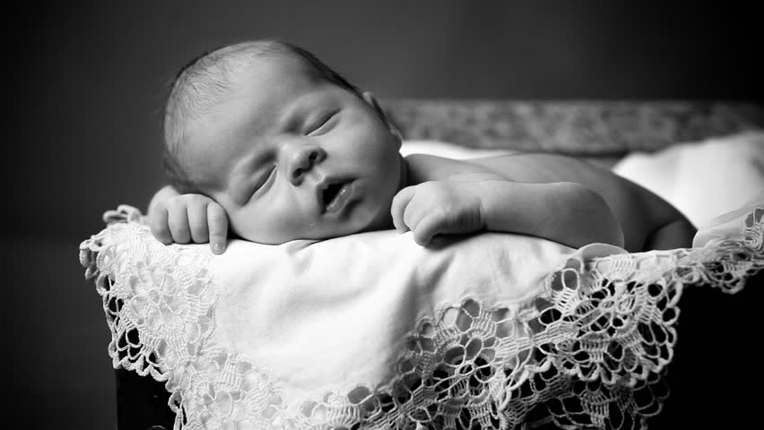 Close-up portrait of a beautiful sleeping baby on vintage suitcase