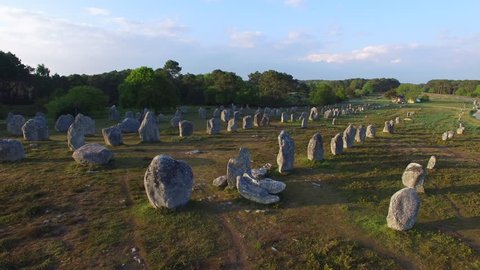 Flying over the famous "Alignements de Carnac" located in Carnac, Morbihan, Brittany, France. Sunset on the Megaliths of Kermario, one of the largest Megalithic complex in the world.