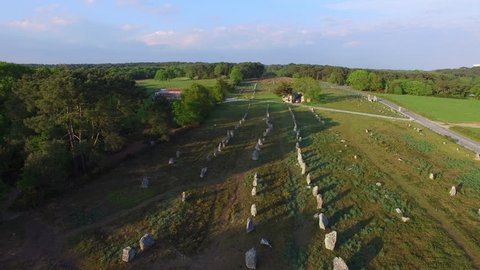 Flying over the famous "Alignements de Carnac" located in Carnac, Morbihan, Brittany, France. Sunset on the Megaliths of Kermario, one of the largest Megalithic complex in the world.